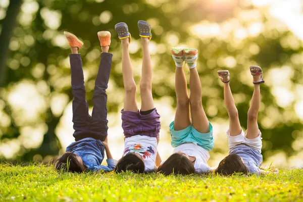 Enfants couchés sur l'herbe Photo De Stock