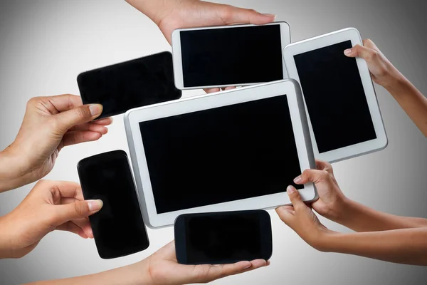 Hands holding tablet computer and mobile phone in different ways