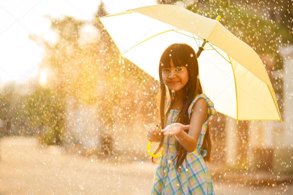 Pretty young asian girl in the rain