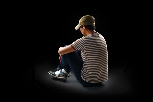 Teenage boy sitting alone — Stock Photo, Image