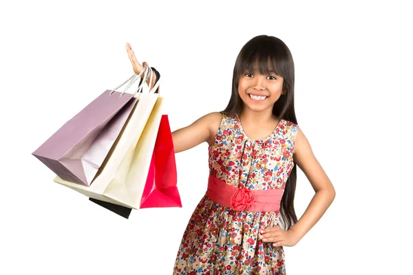 Ázsiai kislány a színes bevásárló szatyrok — Stock Fotó
