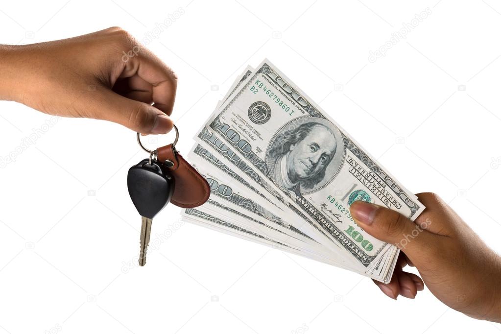 Hand with money and car keys