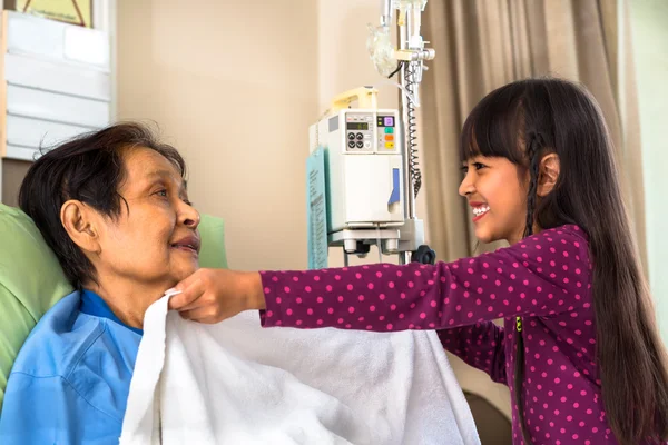 Granddaughter caring about ill grandmother — Stock Photo, Image