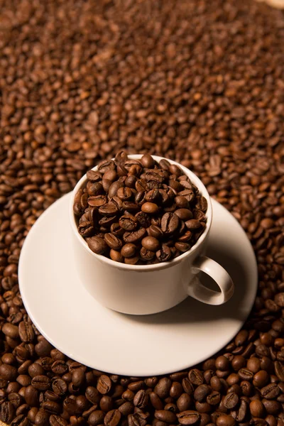 Cup with coffee beans on a dark background — Stock Photo, Image