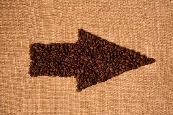 Arrow from the coffee beans isolated on burlap — Stock Photo, Image