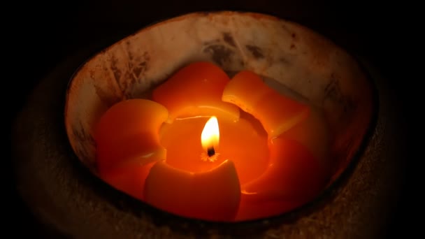 Tropical flower design candle isolated on black background — Stock Video