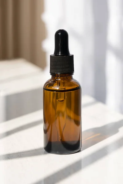 Amber Glass Dropper Bottle Black Lid Natural Sunshine Shadows White — Stock Photo, Image