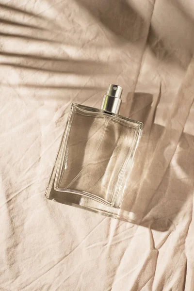 Transparent Bottle Perfume Light Grey Fabric Background Fragrance Presentation Daylight — Stockfoto