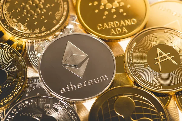 Diğer altın sikkelerin arka planına karşı Ethereum gümüş sikke. Çevrimiçi bankacılık için elektronik sanal şifreli para birimi. İş para birimi teknolojisi kavramı.