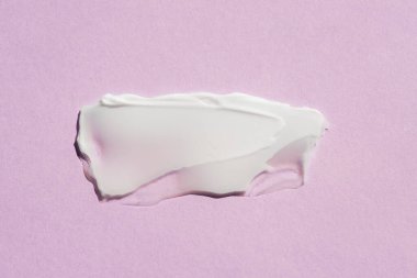 Krem lekesi ya da yüz maskesi. Kremin pembe arka plandaki dokusunun görünümü. Cilt bakım ürünleri, doğal kozmetik ürünleri. Yüz ve vücut bakımı için güzellik konsepti