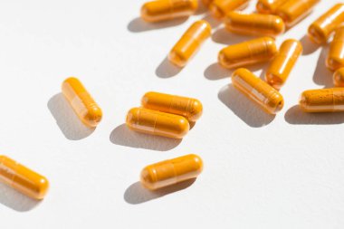 Turmeric plus black pepper extract gelatin capsule close up top view. Herbal supplement organic curcumin. Supports antioxidant health