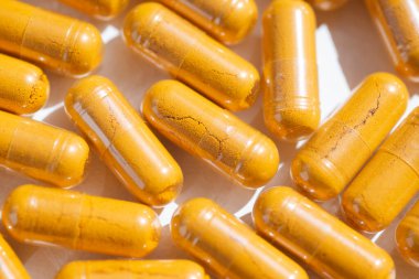 Turmeric plus black pepper extract gelatin capsule close up top view. Herbal supplement organic curcumin. Supports antioxidant health