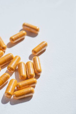 Turmeric plus black pepper extract gelatin capsule close up top view. Herbal supplement organic curcumin. Supports antioxidant health