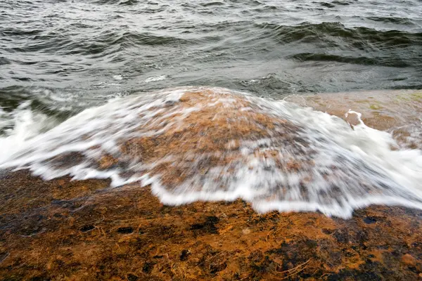 Eau blanche sur roche brune — Photo