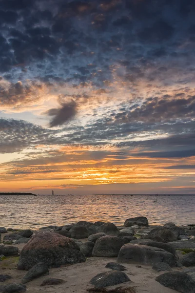 Sunset at sea, rocks in foreground before sea — Stock Photo, Image