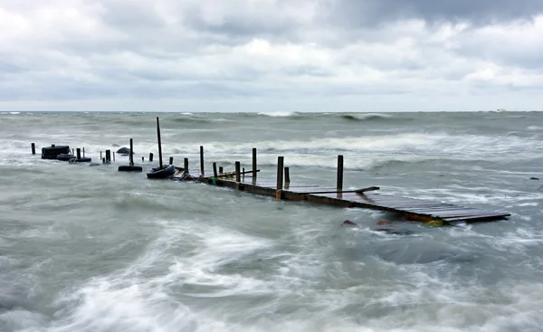 Wood bridge in stormy sea — Stock Photo, Image