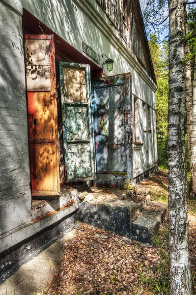 Building with peeling window hatches — Stock Photo, Image