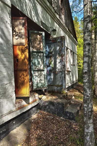 Building with peeling window hatches — Stock Photo, Image