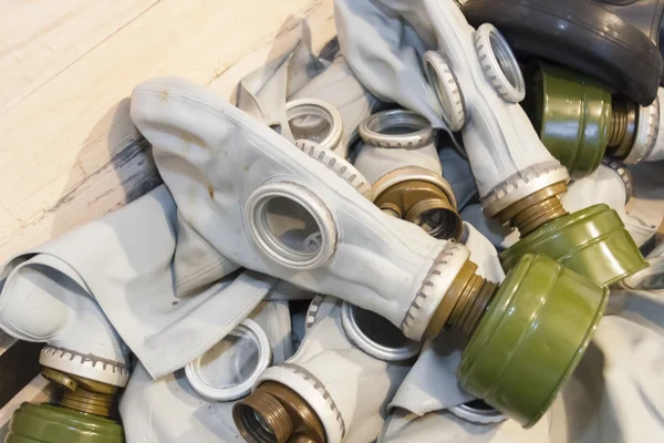 Many gas masks in a chest — Stock Photo, Image