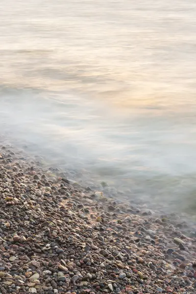 Sea waves on small rocks at seashore — Stock Photo, Image