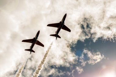 Two flying fighter jets in the sky clipart