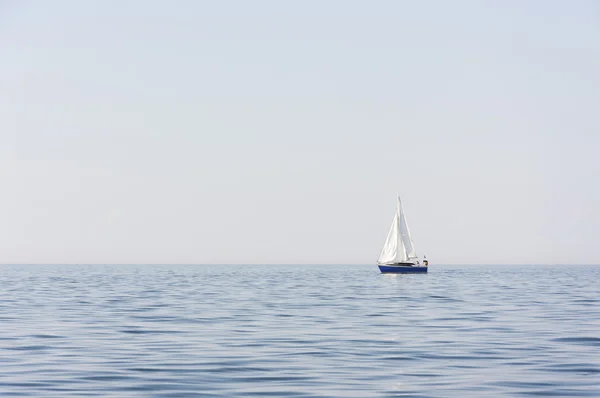 Голубая лодка в море или океане — стоковое фото