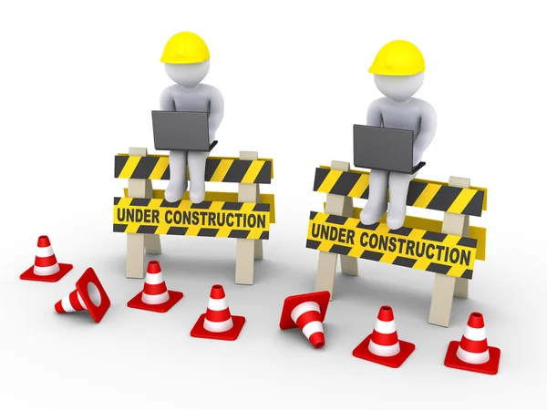 Under construction signs and two workers with laptops — Stock Photo, Image