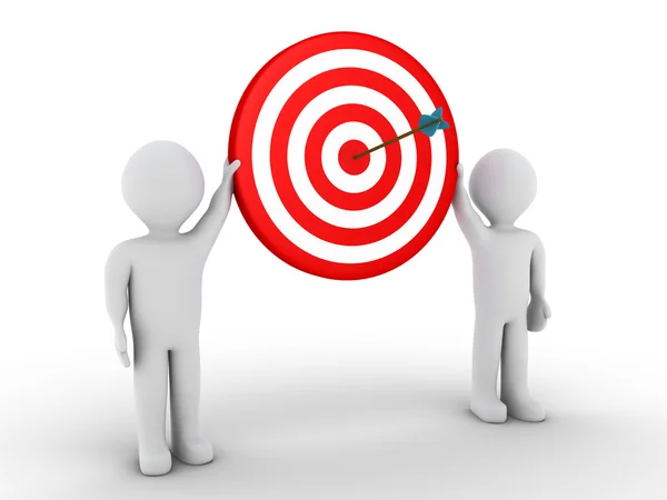 Two people holding target with arrow at the center — Stock Photo, Image