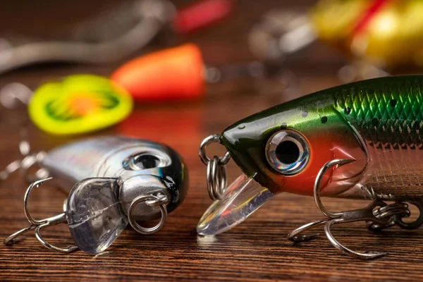 Colorful fishing lures, wobbler, spinner, on wood desk different fishing baits