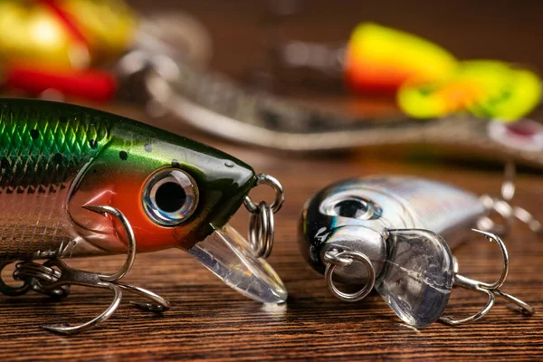 Colorful fishing lures, wobbler, spinner, on wood desk different fishing baits