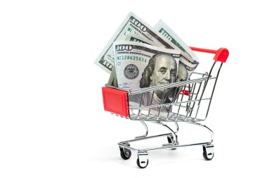 Finansal konsept. İçinde dolar banknotları olan alışveriş arabası. Alışveriş arabasında banknotlar. finansal konsept. Sepette dolar var..