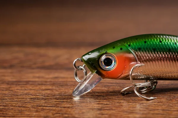 Fishing bait tackle wobbler for fishing on a wooden background.