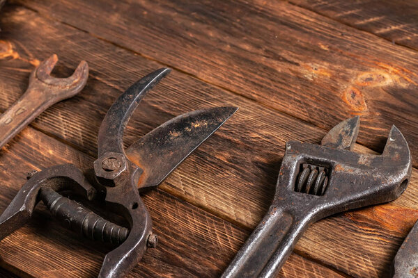 Dirty set of hand tools on a wooden boards.