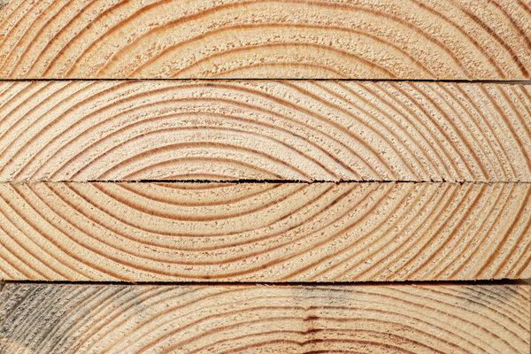 Stacks of pine wood planks. Natural rough wooden boards boards, lumber, industrial wood, timber.