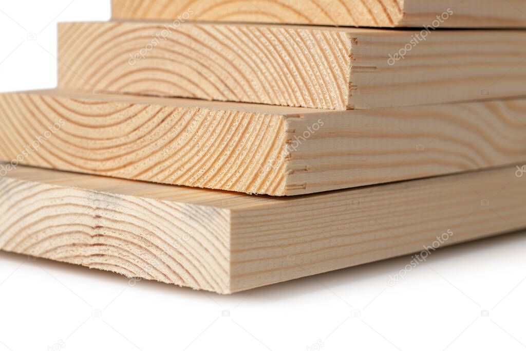 Stacks of pine wood planks on white. Natural rough wooden boards boards, lumber, industrial wood, timber.