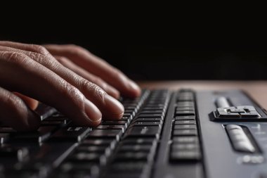 Eller bilgisayarda çalışır, klavye çalar, modern ofiste proje planlar, kapat. Yönetici müdürü, şirket adamı iş raporunu masasında düzeltiyor.