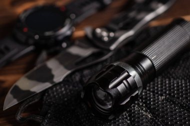 Everyday carry EDC items for men in black color - flashlight, watch and knife. Survival set. Minimal concept