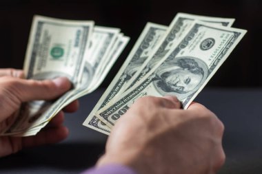 Erkek eli kapalı, bize dolar sayıyor. Finansal iş kavramı