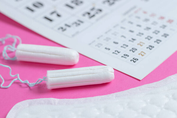 Woman hygiene protection, menstruation calendar and clean cotton tampons and gasket pad