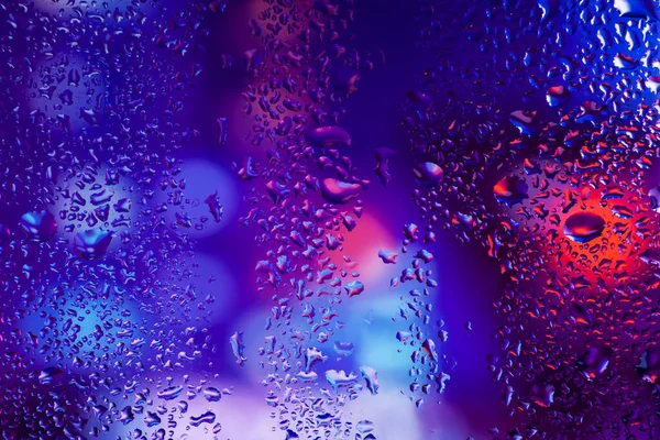 Condensation on the clear glass window. Water drops. Rain. Abstract background texture.