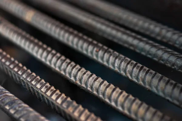 Stack of heavy metal reinforcement bars with periodic profile texture. Close up steel construction armature. Abstract industrial background concept.