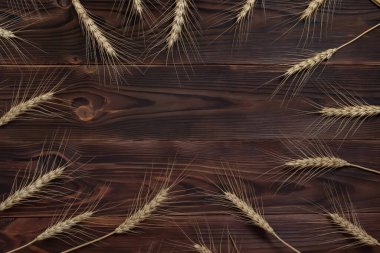 Wheat ears bunch on rustic wooden background