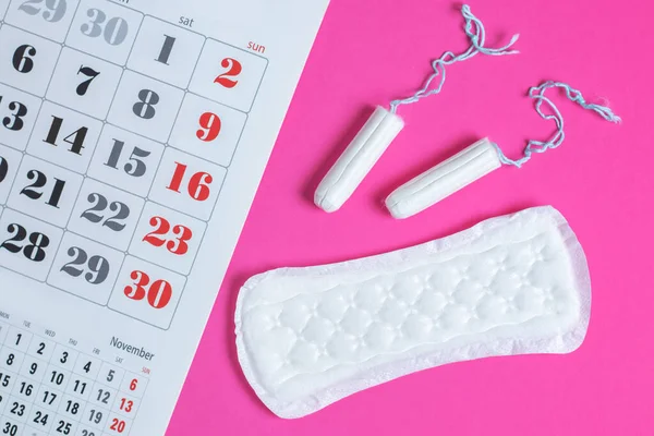 Woman hygiene protection, menstruation calendar and clean cotton tampons and gasket pad