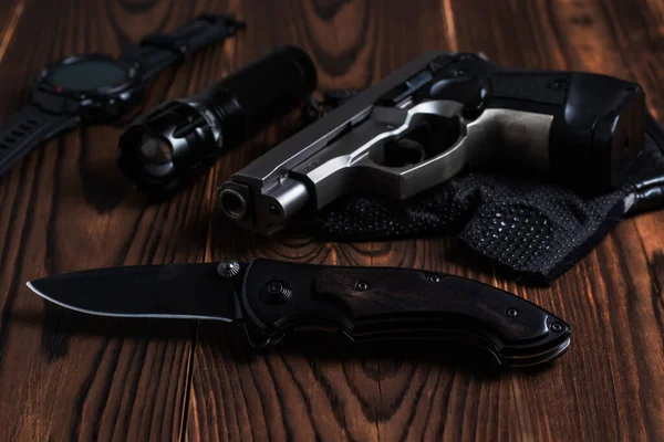 Folding Pocket Knife Pistol Flashlight Wooden Background — Foto Stock
