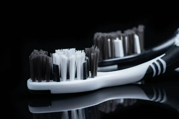 Two Toothbrushes Black White Color Dental Care Lies Black Background — Stock Photo, Image