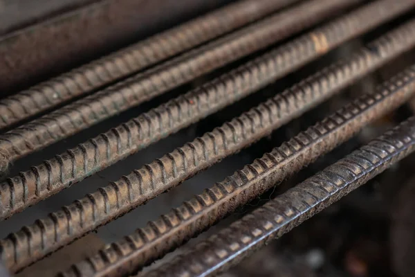 Stack of heavy metal reinforcement bars with periodic profile texture. Close up steel construction armature. Abstract industrial background concept.