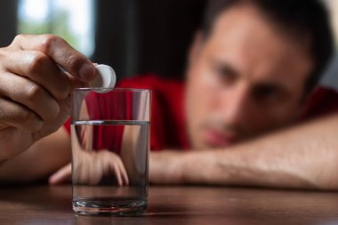 Man With Hangover Taking Medicine Pill Cure.