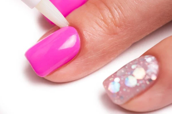 Cuticle gel. Master applies cuticle gel in the beauty salon. Professional care for hands