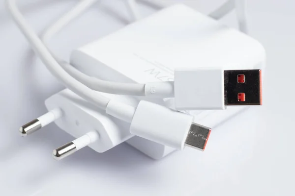 White charger with usb cable on white background