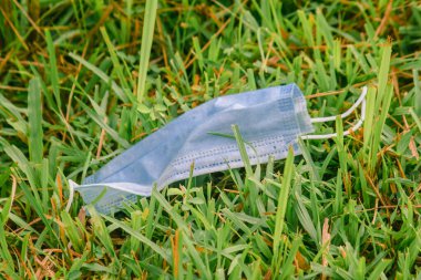 Tek kullanımlık tıbbi maskeler çimlere çöp gibi atılmıştı.